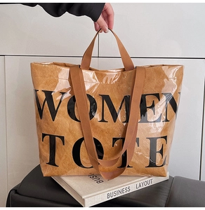 Close-up of brown textured tote bag with transparent PVC coating and black text
