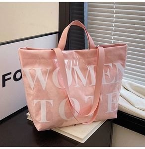 Detailed macro view of the pink large-capacity tote bag with Women Tote white lettering