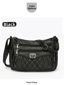 Detail of black quilted crossbody bag with functional zippers and metallic hardware