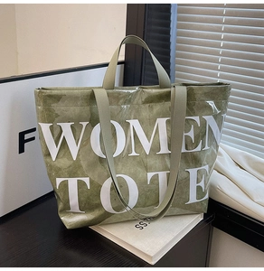 Close-up of green marble-textured tote bag with WOMEN TOTE text in natural lighting