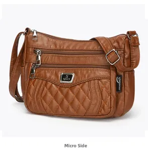Close-up of brown quilted soft leather crossbody bag with multi-pocket zipper detail
