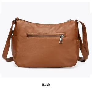 Rear view of brown quilted faux leather crossbody bag with a silver zipper pocket