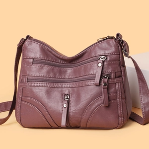 Classic dark purple leather crossbody bag with multiple zippers and adjustable strap