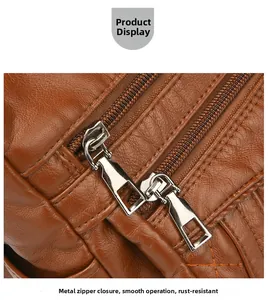 Close-up of smooth silver zippers and brown litchi pattern leather on a crossbody bag