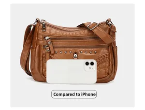 Brown soft faux leather crossbody bag size comparison next to a white iPhone device