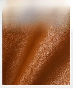 Close-up of brown litchi pattern leather showing soft texture and fine stitching detail