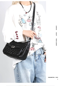 Close-up of quilted cowhide shoulder bag with multi-layer zippers on a fashion model
