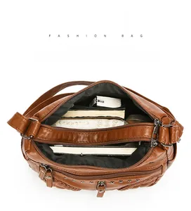 Top view showing large capacity and multi-layer storage of brown faux leather crossbody bag