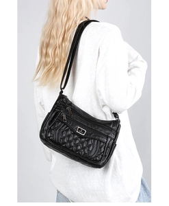 Detail of black quilted crossbody bag with multi-zipper pockets and metal logo plate