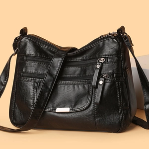 Black washed leather crossbody bag with multiple zippers and adjustable shoulder strap