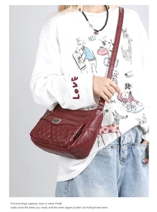 Detail of dark red quilted crossbody bag featuring multiple zipper pockets and large capacity