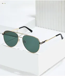 Detailed shot of gold metal aviator sunglasses with green lenses on a white pedestal