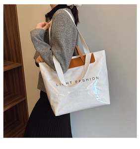 Détail du sac fourre-tout en papier Dupont blanc avec poignées en cuir marron et logo