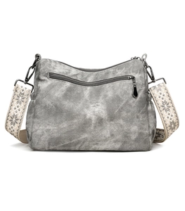 Detail of vintage grey washed tote bag featuring a decorative woven jacquard shoulder strap