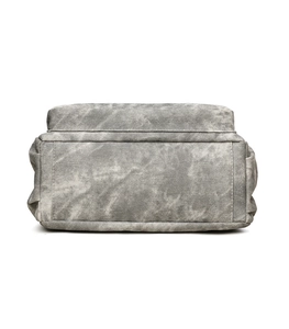 Detailed close-up showing the grey washed canvas texture and side fold of the tote bag
