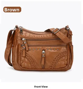 Front view of brown textured leather crossbody bag with multiple zipper pockets