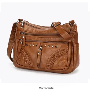 Brown vintage faux leather crossbody bag with multi-layer zippers and rivet details