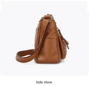 Side view of soft brown leather crossbody bag featuring multi-layer storage and side pockets