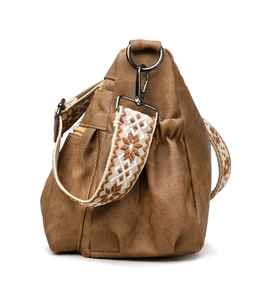 Close-up of brown soft leather tote bag showing side pocket and geometric shoulder strap