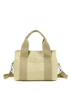 Detail of canvas tool bag featuring wide handles, front pocket and metal hooks