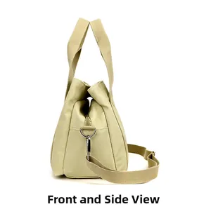 Detailed side view of khaki canvas tool bag with reinforced handles and shoulder strap