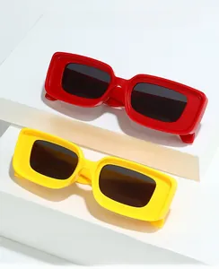 Detail of vintage square sunglasses in bright red and yellow with thick plastic frames