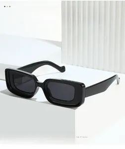 Detail of black rectangular sunglasses with a layered frame design on a white pedestal
