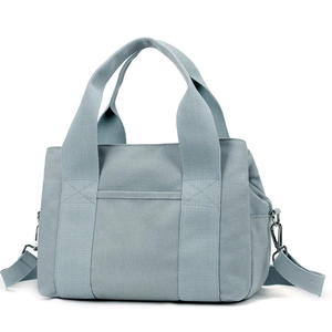 Light blue canvas crossbody tool bag with dual handles and adjustable shoulder strap