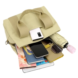 Durable beige canvas tote bag showing large capacity for tablet, umbrella and daily items
