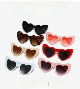 Flat lay of heart-shaped cat-eye sunglasses in seven trendy assorted colors