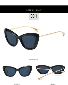 Dettaglio occhiali da sole cat eye con montatura nera e sottili stanghette in metallo oro