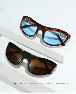 Detail of tortoise and black cat-eye glasses with hollow metal frames on a white stand
