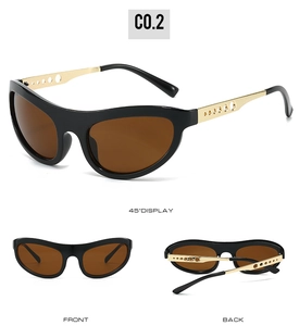 Detail view of cat eye sunglasses with gold hollow metal temples and brown lenses