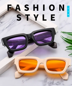 Close-up of retro square sunglasses in black-purple and beige-orange on marble background