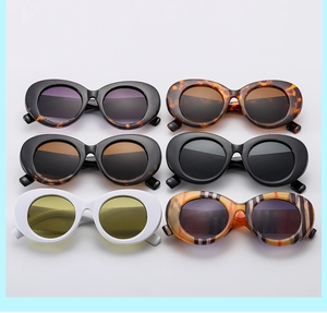 Matrix display of oval sunglasses in retro tortoiseshell, white, and striped patterns