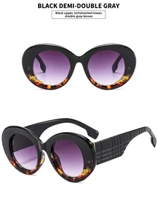Detail of oversized retro sunglasses with black demi frames and gradient gray lenses