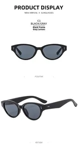 Detail of small cat-eye sunglasses with glossy black frames and silver rivet accents