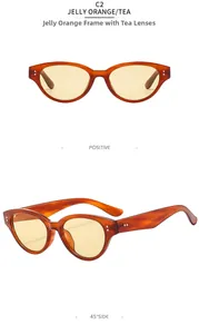 Detail view of cat eye sunglasses in jelly orange frame with yellow brown lenses and rivets