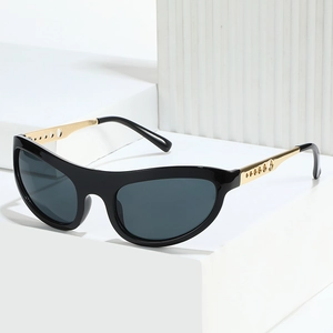 Fashionable cat eye sunglasses with black frames and gold hollow metal temples
