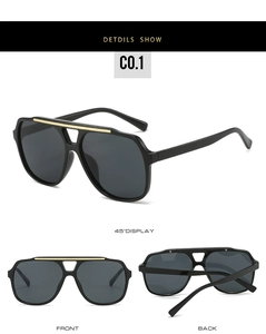 Detail view of double-bridge aviator frames with gold metal accent and gray lenses