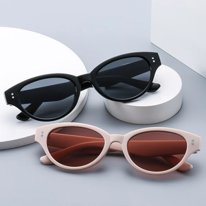Fashionable cat eye sunglasses in black and beige frames with trendy silver rivet accents