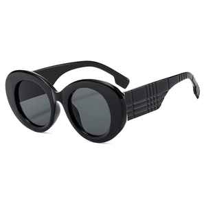 Fashionable oversized oval black sunglasses with textured plaid pattern on temples