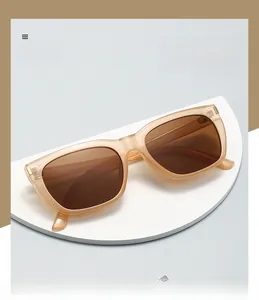 Detail view of square PC sunglasses with champagne frames and brown polarized lenses