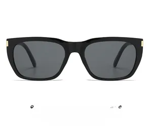 Detailed view of black square sunglasses with metallic rivets and dark grey lenses
