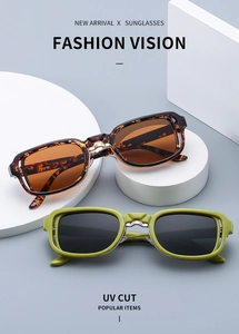Detail of square vintage sunglasses showing tortoise and green frames on geometric podiums