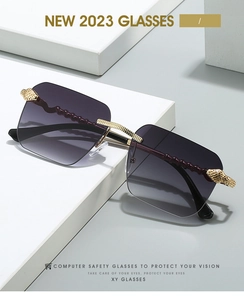 Détail de lunettes de soleil sans monture avec écaille de serpent et branches rouges