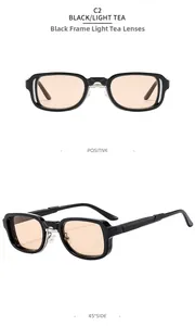 Detail view of stylish black rectangle sunglasses with light tea lenses and hollow frames
