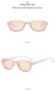Detail view of pink frame rectangular sunglasses with tea lenses and gold metal accents
