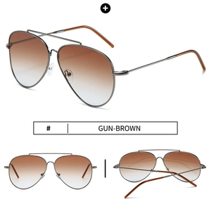 Detail of gunmetal aviator sunglasses with brown gradient lenses and stainless steel frame