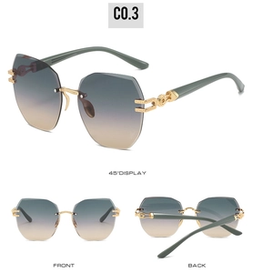 Detail view of rimless geometric sunglasses with gold hollow temples and gradient lenses